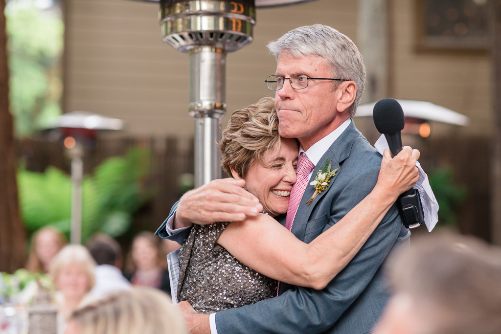 mother of the groom hugging father of the bride
