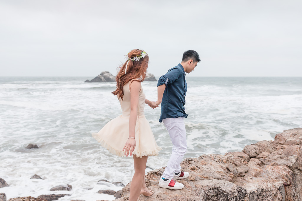 romantic and candid San Francisco engagement photo by the ocean