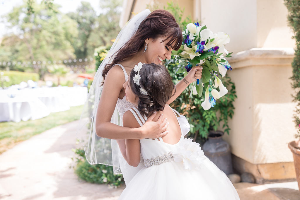 bride hugging the flower girl