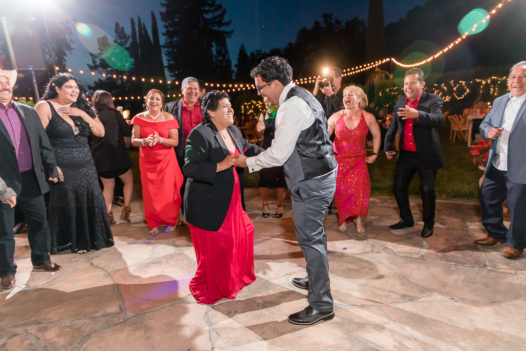 groom dancing with wedding guests