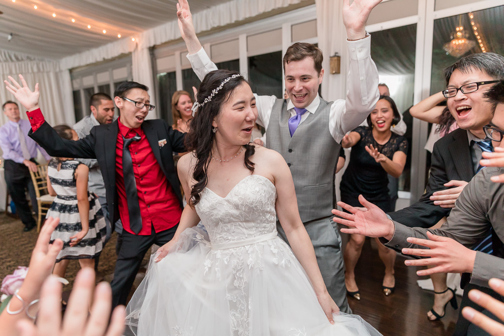 bride and groom owning the dance floor surrounded by their guests
