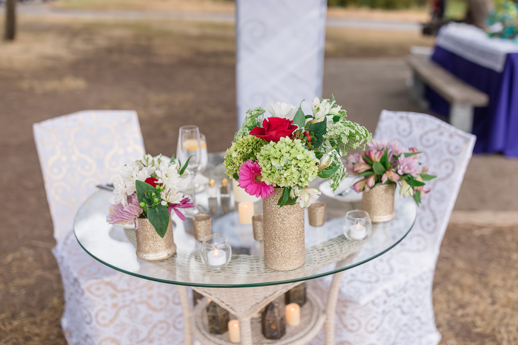 a private table decorated with flowers, candles and lanterns