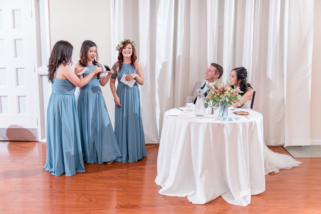 bridesmaids singing a song for the bride and groom
