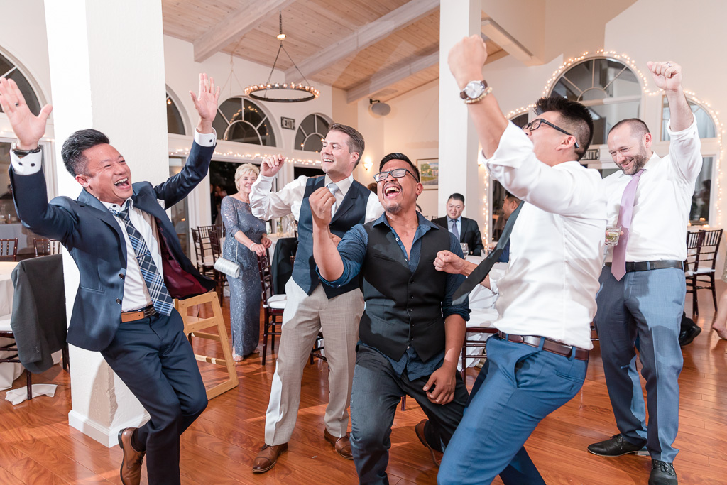 groom dancing with his buddies during wedding reception