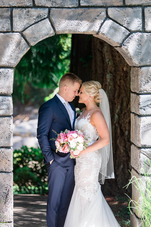 a moment together under a stone structure