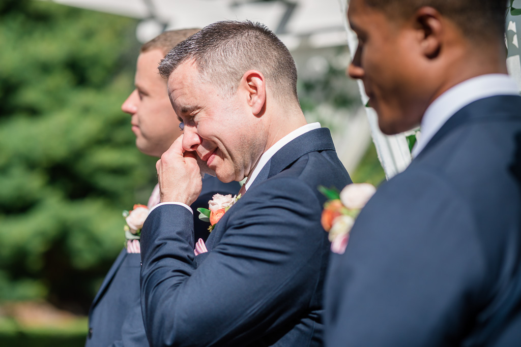 groomsman crying during the vow exchange