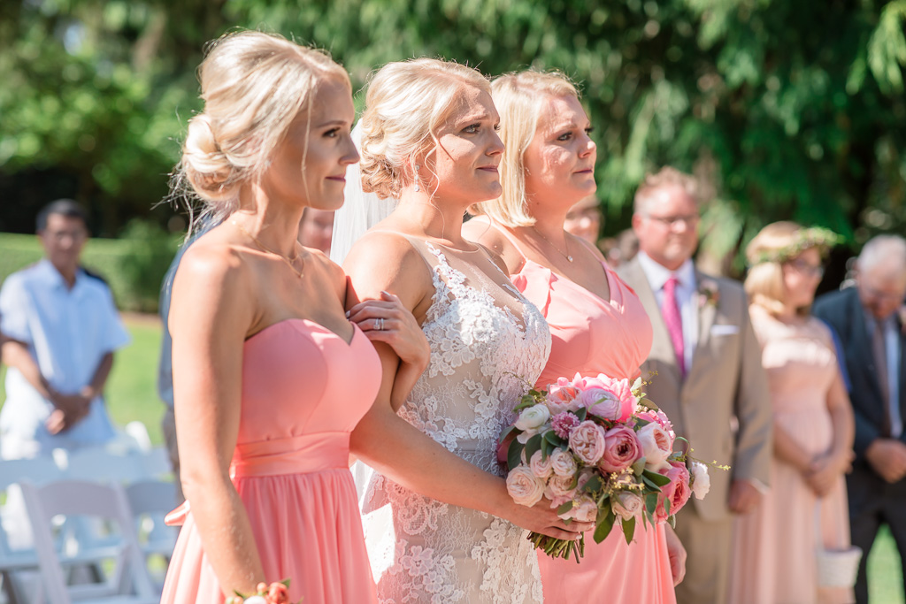 bride and her sisters walking down the aisle