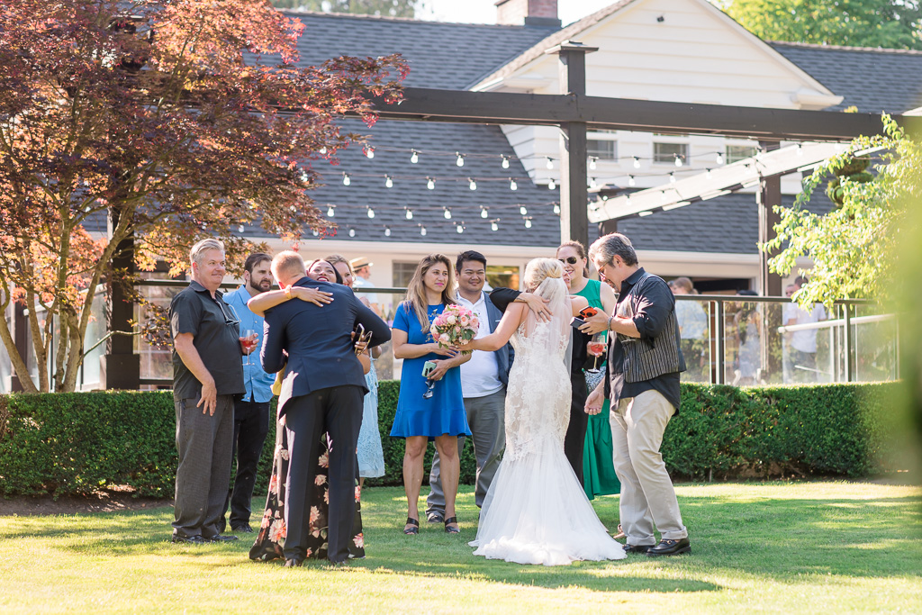 newlyweds greeting their guests on the property