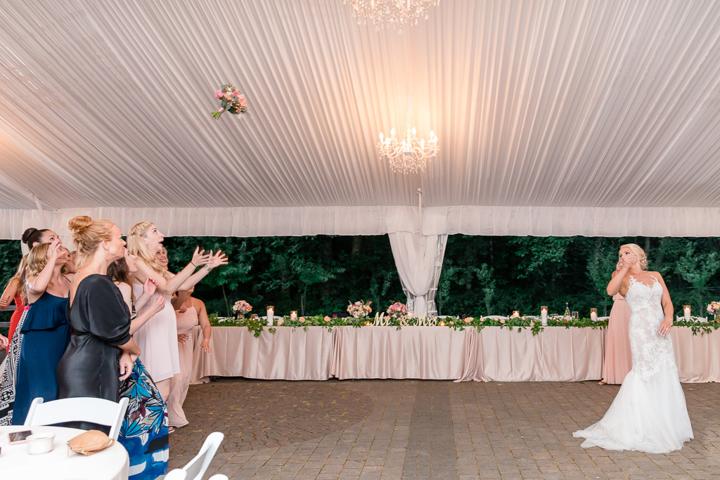 epic bouquet toss at the Rock Creek Gardens wedding reception