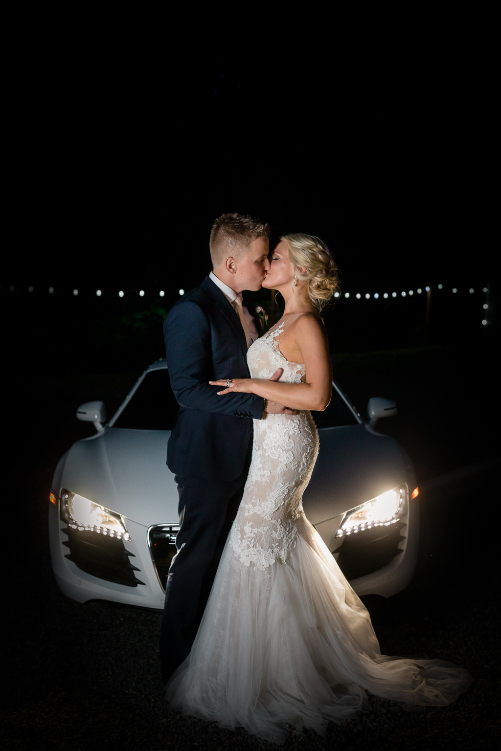creative night photo of a Rock Creek Gardens wedding of the bride and groom in front of their car