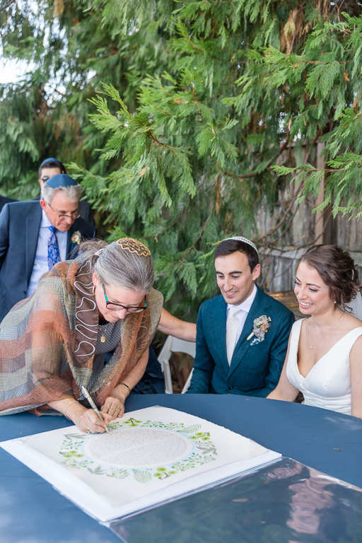 rabbi signing the ketubah - Napa Jewish wedding