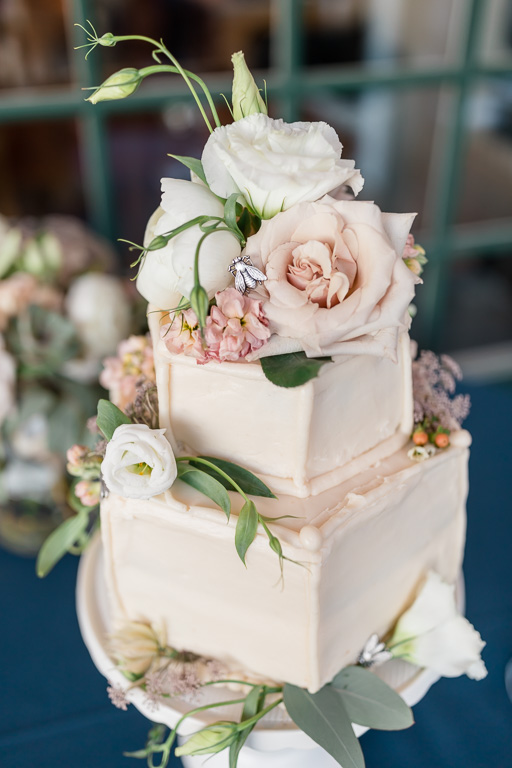 pastel color wedding cake with a cute little bee on top