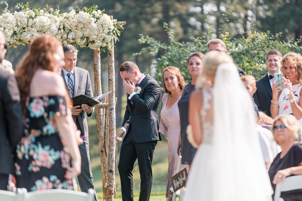 groom sobbing with emotion as bride walks down the aisle - Lake Tahoe outdoor wedding