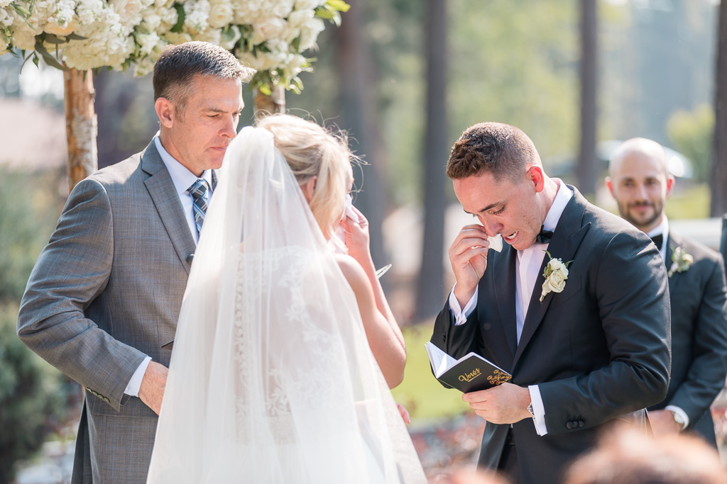 emotional Lake Tahoe wedding - bride and groom both crying during their vow exchange