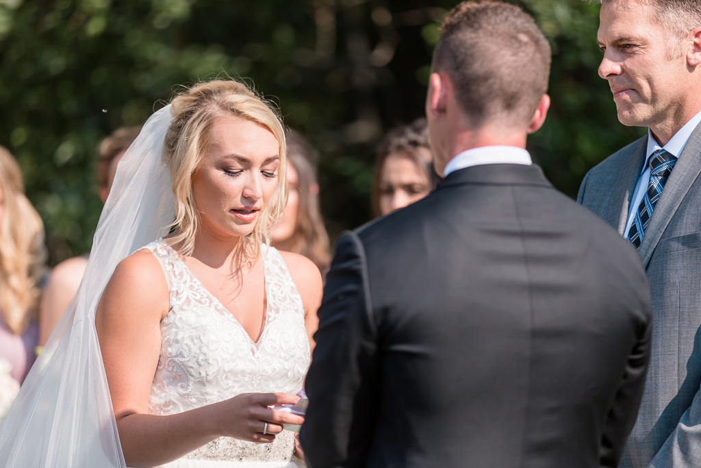 bride's tears rolling down her cheek when reading her vows