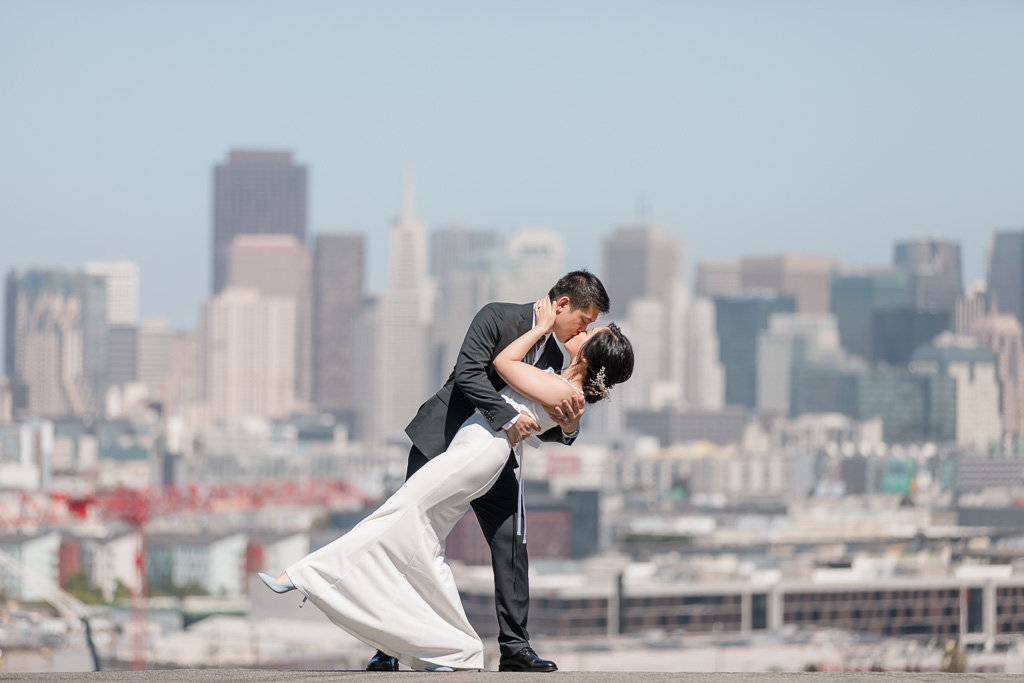 San Francisco wedding photo on top of the city with the skyline behind them