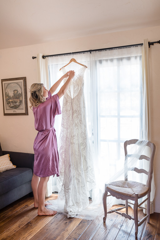 bride getting her wedding gown down