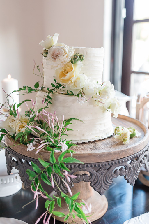 a simple wedding cake decorated with flowers