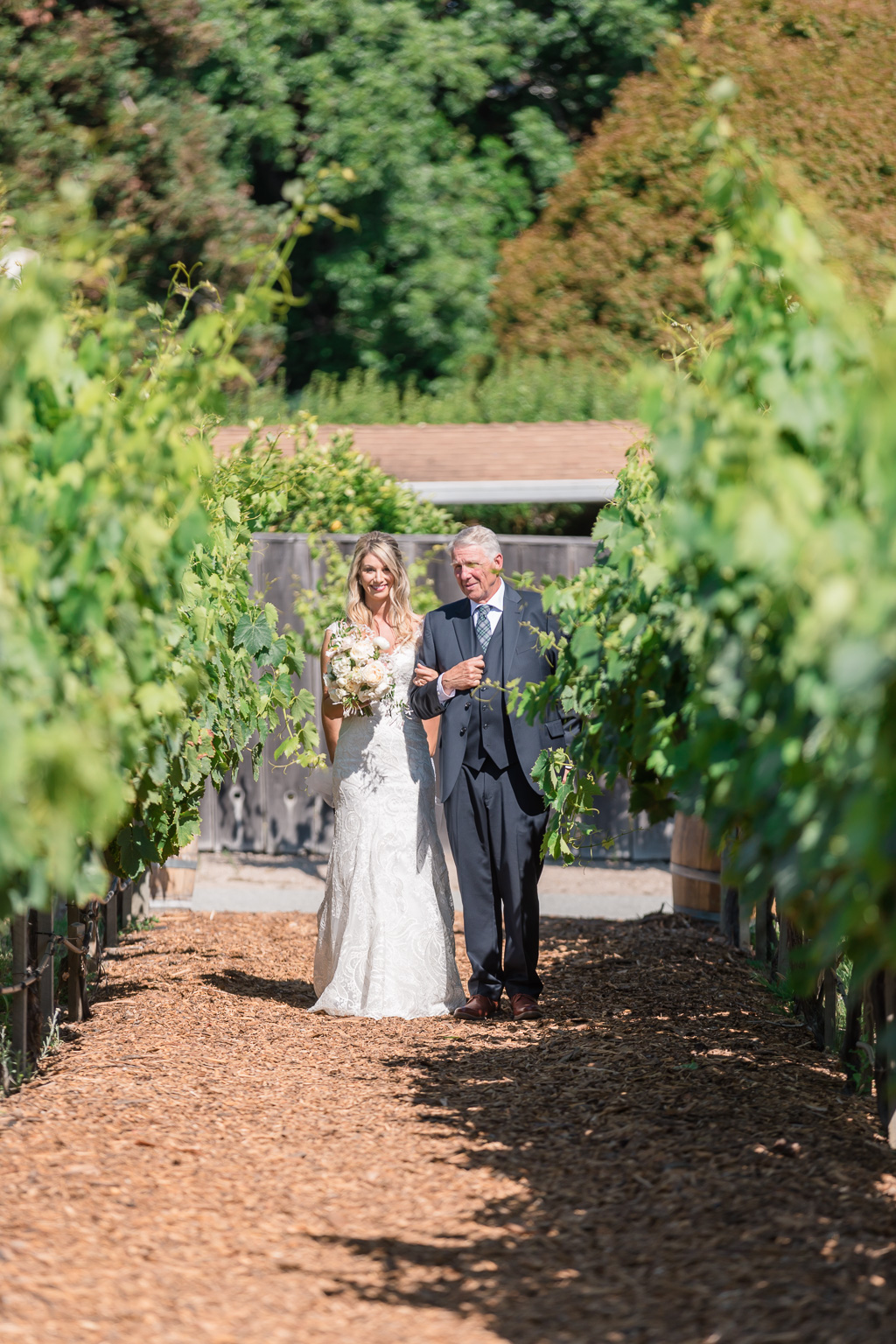 bride and father waiting inside the vineyards