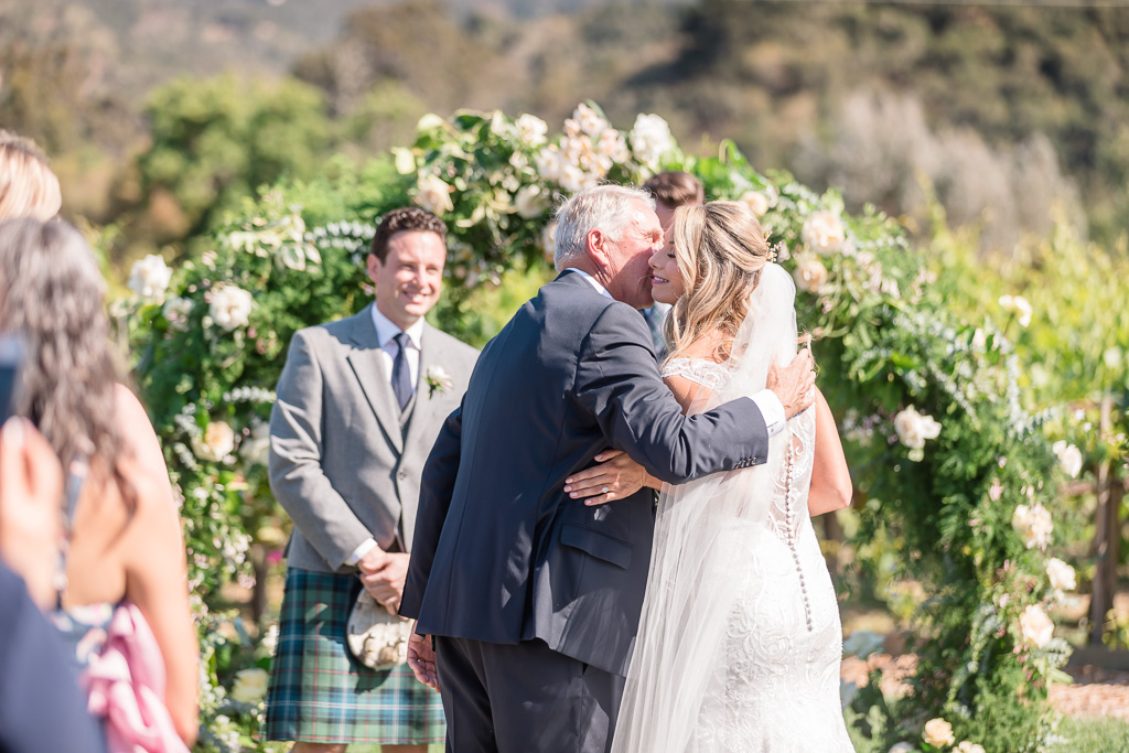 the emotional moment when father giving the bride away at a Carmel-by-the-Sea summer wedding