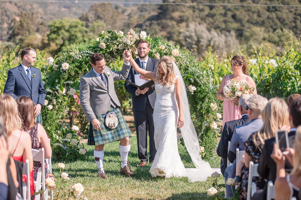 wedding ceremony with a circle arch and kilts
