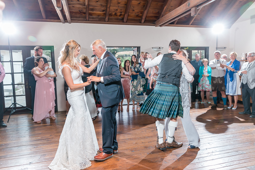 bride and groom dance with their parents at the same time