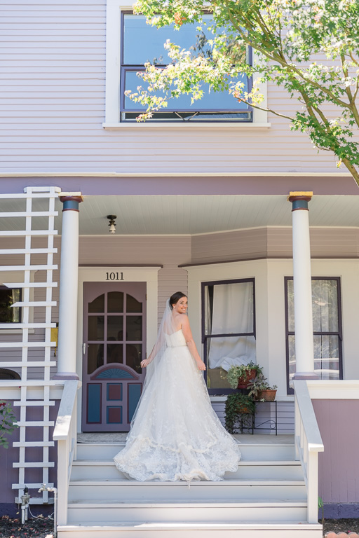 a back shot of the bride in front of the house they got ready at