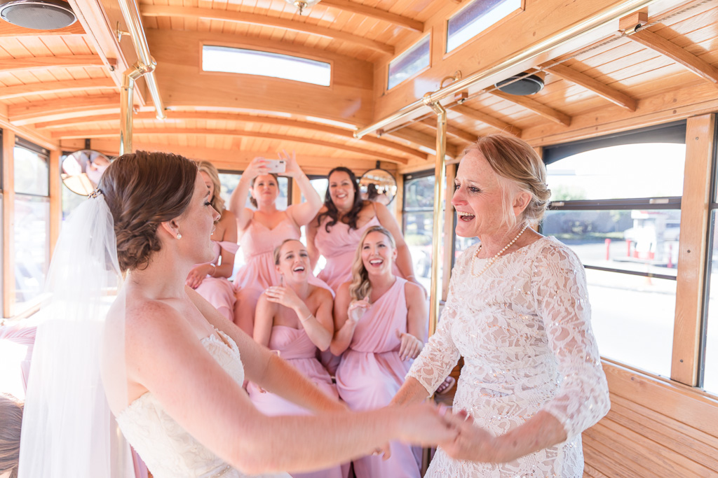 bride and mother dancing on the bus