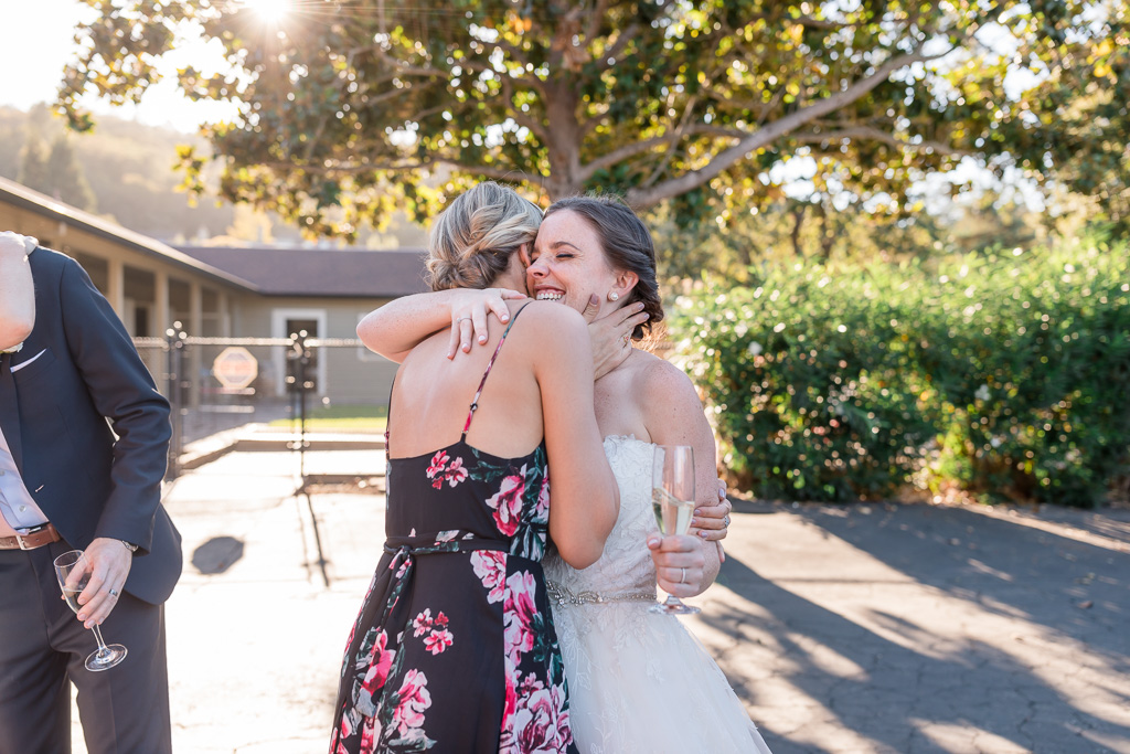 bride hugging and mingling with guests during the cocktail hour