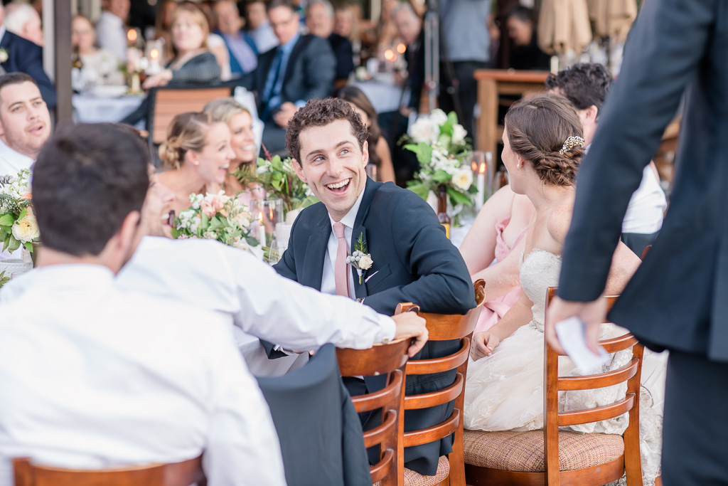 groom laughing at a hilarious toast