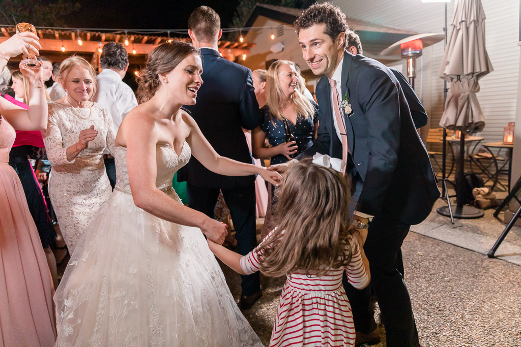 newlyweds dancing with their little guest