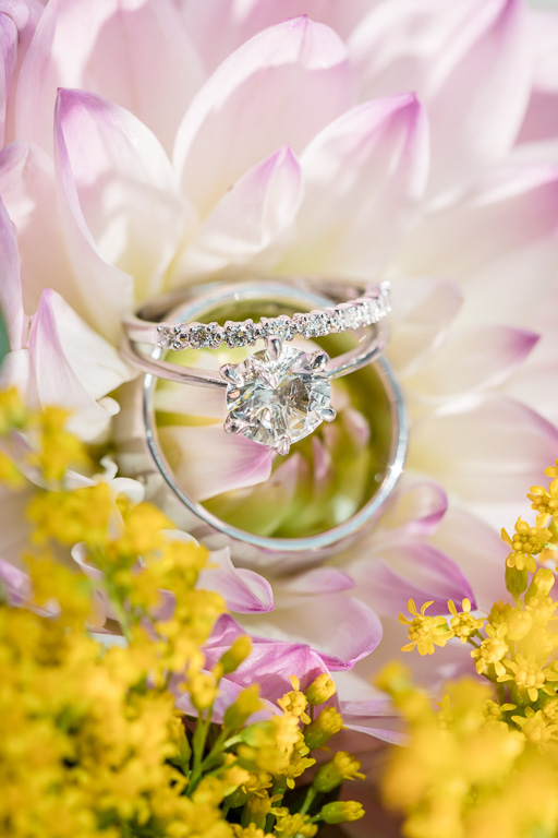 diamond wedding ring set laying on flowers