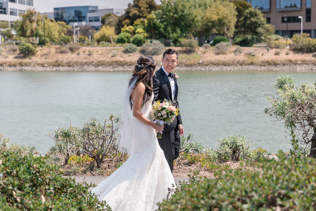 candid Oyster Point waterfront walking wedding photo after the first look