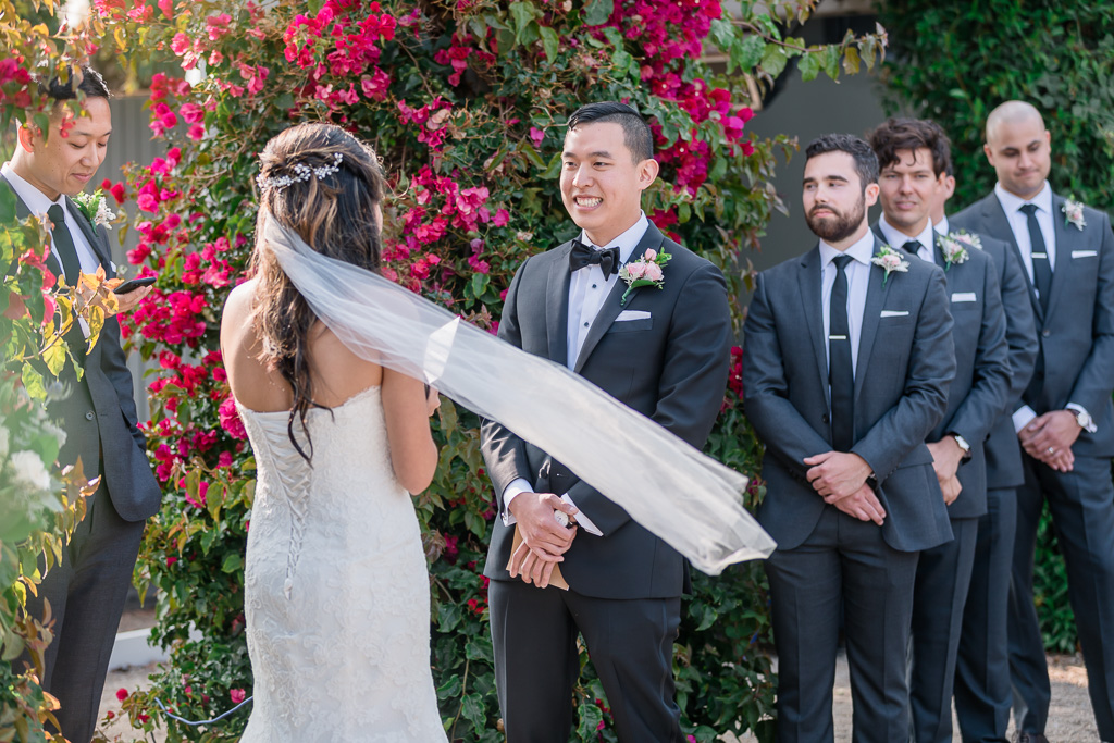 groom smiling at his bride during their vow exchange