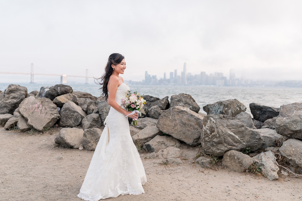 stunning bride at Treasure Island waterfront overlooking the city skyline