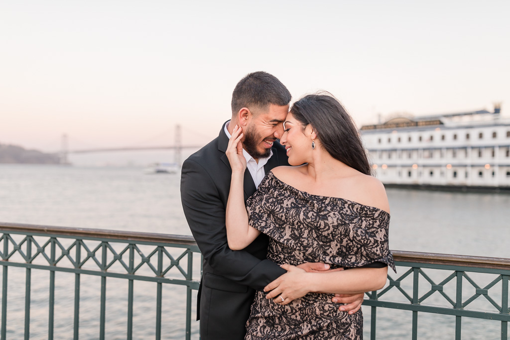 Embarcadero Pier 7 engagement photo with Bay Bridge in the background