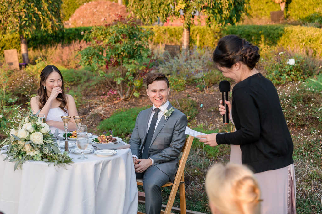 bridesmaid giving funny toast to bride and groom
