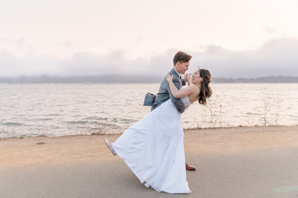 wedding portrait along Tiburon shoreline with rolling fog in the background