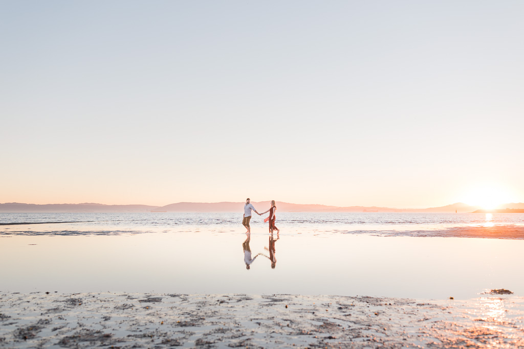 San Francisco engagement photo of couple floating and walking in the water