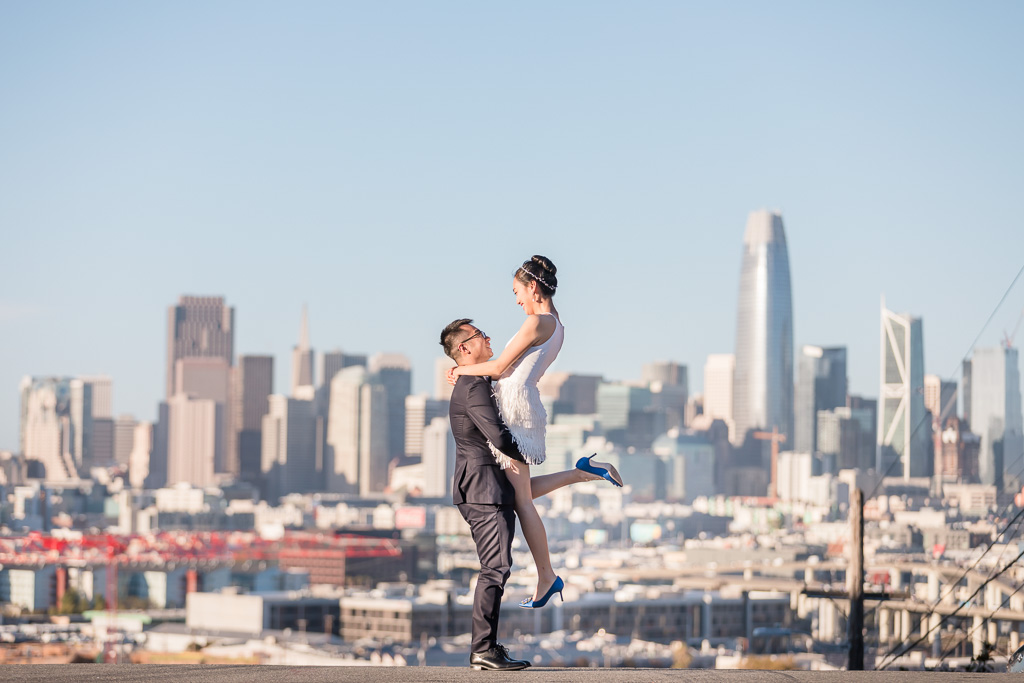 wedding photo lift up in front of San Francisco city skyline