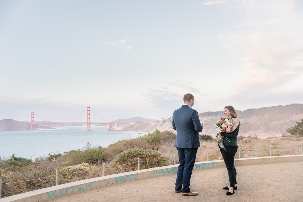 surprise proposal on the lands end trail in front of the golden gate bridge
