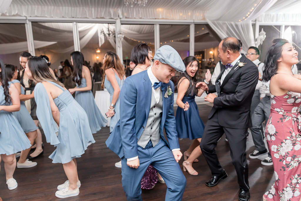 groom showing off some moves on the dance floor