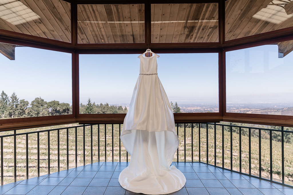 elegant wedding gown hanging on the window of Thomas Fogarty Winery