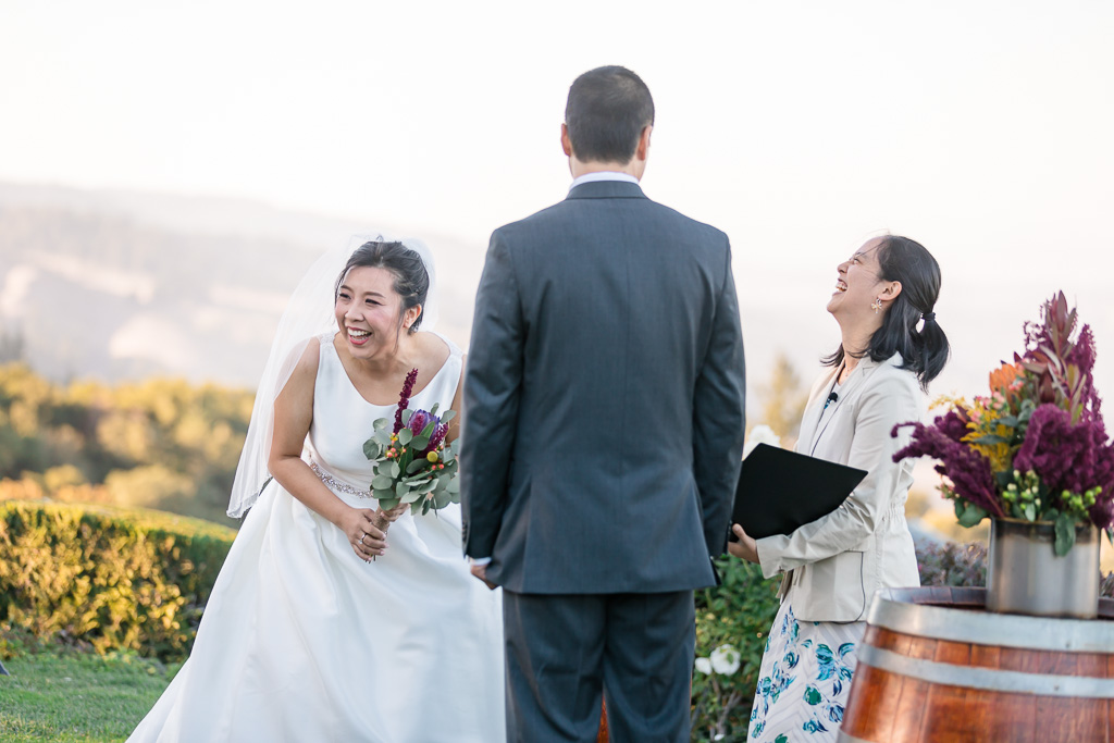 bride laughing hard during the ceremony