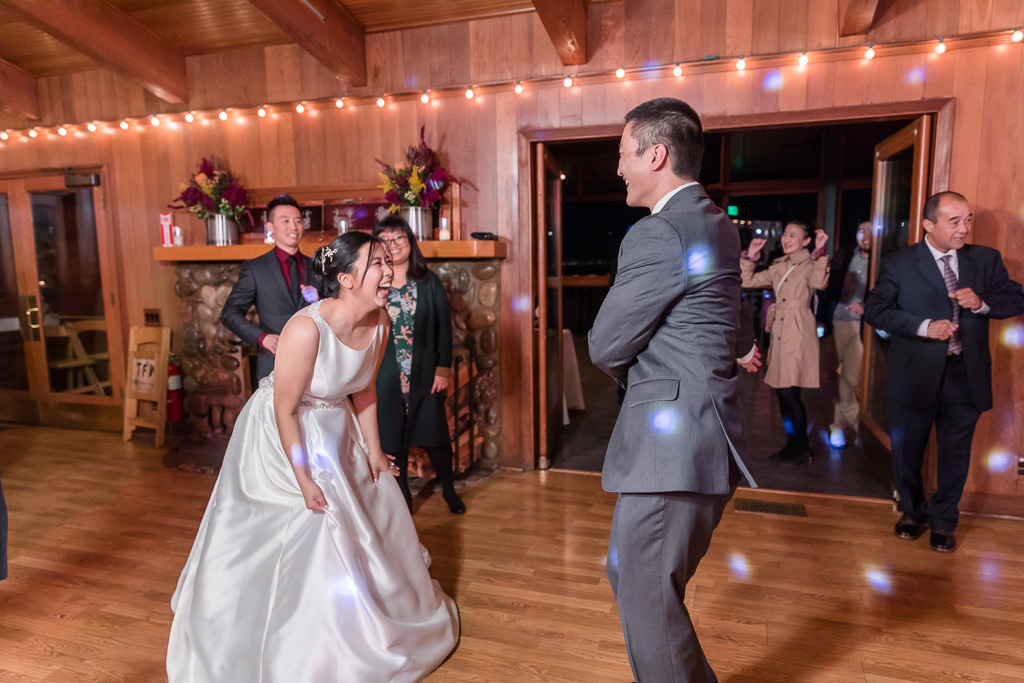 bride laughing hard at groom's goofy dance moves
