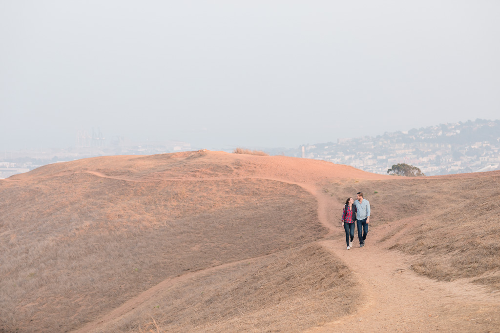 newly engaged couple casually walking at Bernal Heights