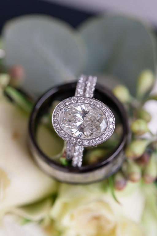 round cut halo diamond engagement ring and matching wedding band close-up