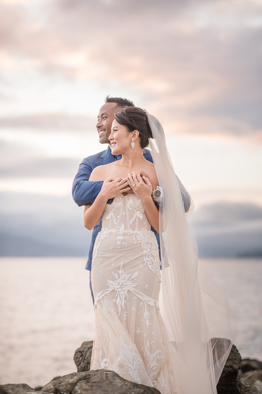 wedding photo with a dramatic colorful sky over the ocean