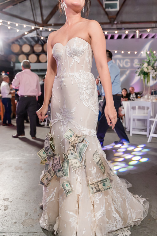 bride with dress full of cash after money dance