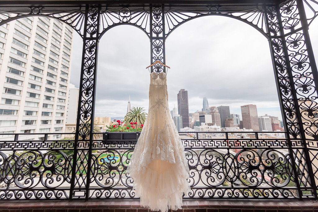 Idan Cohen wedding dress hanging on Fairmont SF room balcony